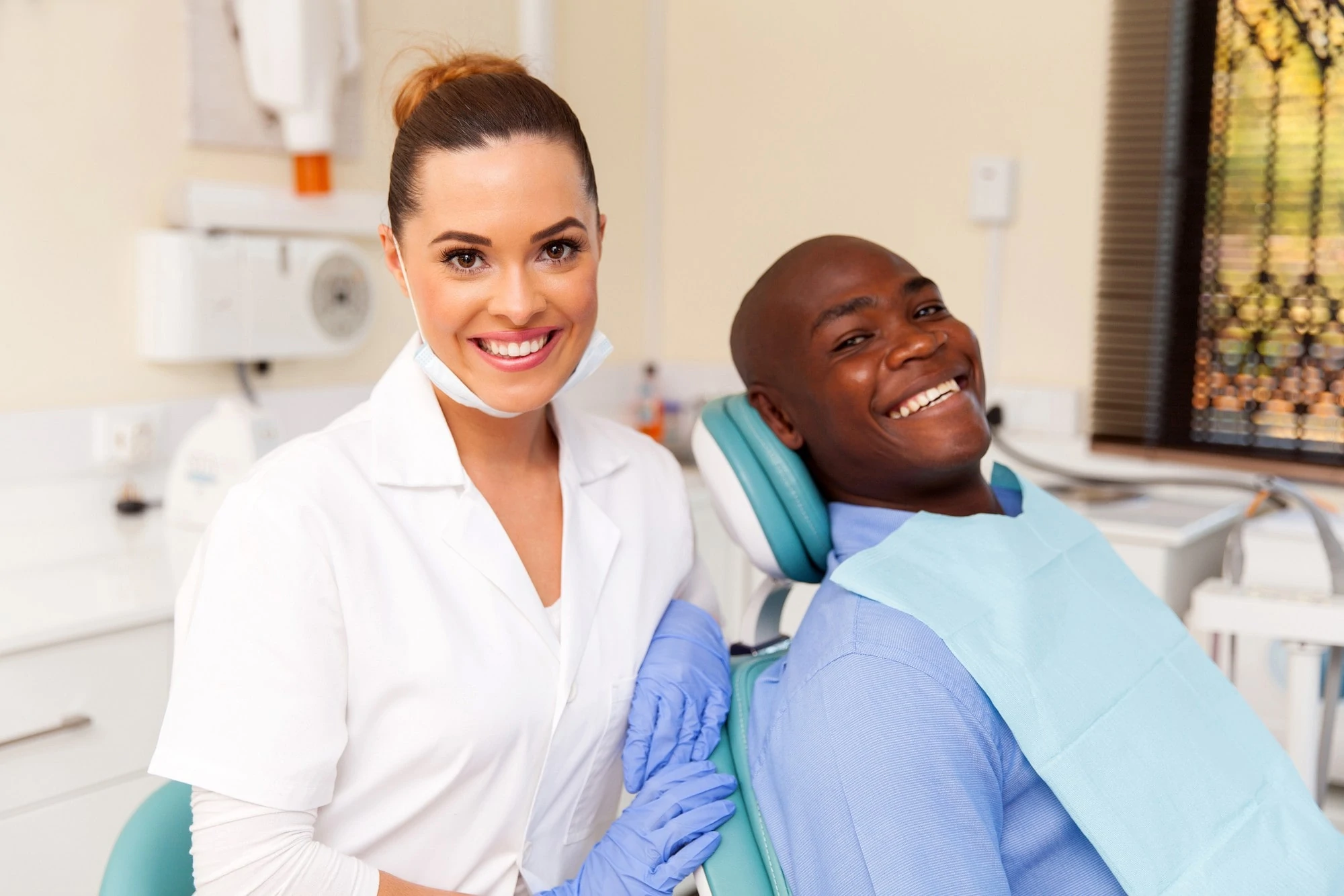 A Smiling Man And Woman Sitting Together In A Dental Chair